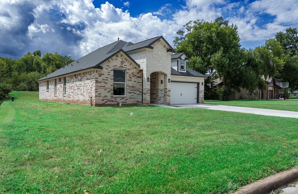 Front and side of the home with its lawn